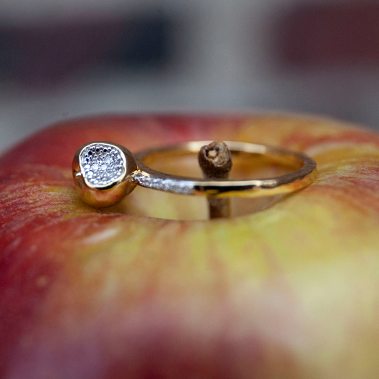 Lifestyle image of Equal To The Core gold-plated Apple ring by Pavé The Way® Jewelry
