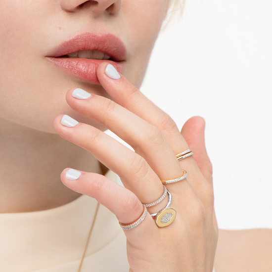 Model wearing diamond stackable bands with One-In-A-Melon ring by Pavé The Way® Jewelry