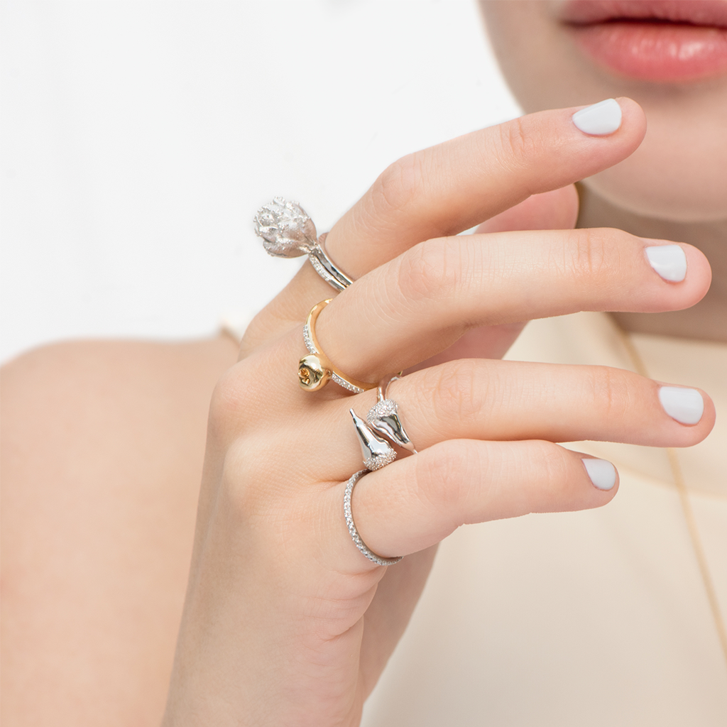 Model wears Get To The Heart Of The Matter sterling silver Artichoke ring with stackable rings by Pavé The Way® Jewelry