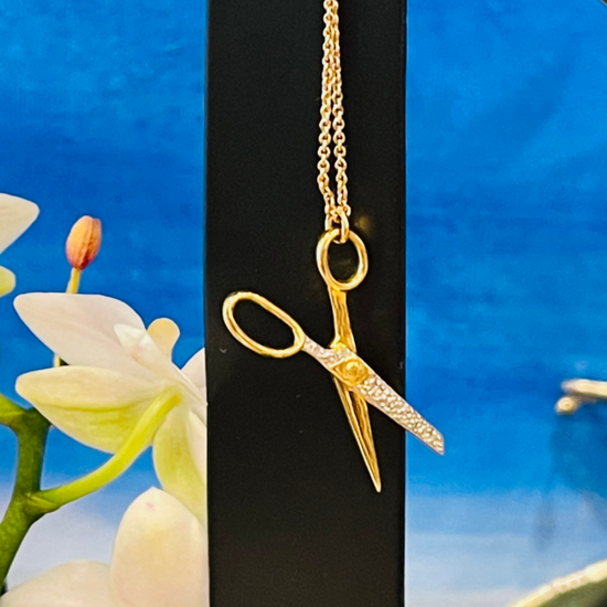 Lifestyle image of Cut Out Stereotypes gold-plated Scissor necklace by Pavé The Way® Jewelry