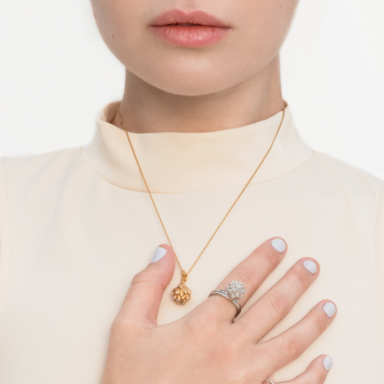 Model wears Get To The Heart Of The Matter Artichoke sterling silver ring and gold-plated necklace by Pavé The Way® Jewelry