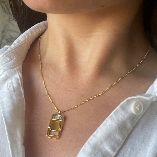Model wears Take A Set gold-plated Chair necklace by Pavé The Way® Jewelry