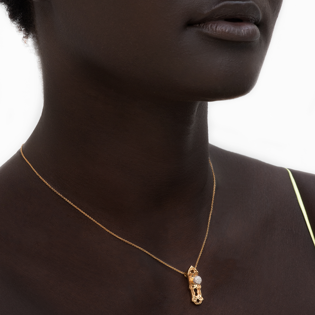 Load image into Gallery viewer, Model wearing Check Your Bias At The Door gold-plated Door knob necklace by Pavé The Way® Jewelry
