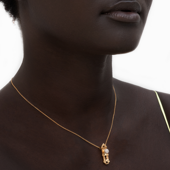Model wearing Check Your Bias At The Door gold-plated Door knob necklace by Pavé The Way® Jewelry